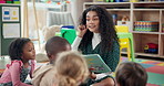 Woman, teacher and reading lesson with book in nursery for storytelling, education or learning at elementary school. Female person, educator or kids with story for listening activity at kindergarten