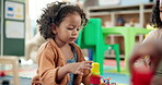 Child, student and stack blocks in classroom for learning, problem solving and creative activity. Kid, talk and building toys for education game, puzzle solution and motor development in kindergarden