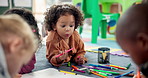 Children, shock and art drawing for poster, learning and development in montessori classroom. Kids, khoki and together for collaboration, teamwork education and students play on carpet at academy