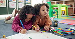 Art, school and children drawing for poster, learning and development in montessori classroom. Kids, girls and together for collaboration, teamwork education and students play on carpet at academy