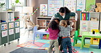 Teacher, hug and children in preschool, smile and care for students in classroom, happiness or youth. Embrace, kids and woman in kindergarten for education, knowledge or group with trust for educator