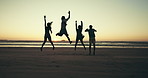 Jumping, friends and people on beach at sunset for holiday, summer vacation and adventure together. Nature, travel and men and women by sea, ocean and waves for freedom, happy and fun on weekend
