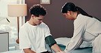 Doctor, woman and man with blood pressure test for hypertension, circulation and assessment at hospital. People, medic and patient with check, cardiology and services for wellness on bed at clinic