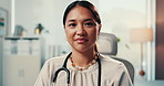 Woman, doctor and face in office at clinic with pride, confident and medical career. Person, smile and portrait for healthcare services, job and stethoscope for wellness at hospital in Malaysia