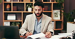 Documents, laptop and businessman writing for research, information or report on company budget. Computer, paperwork and male financial manager with investment planning for corporate dividend.