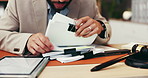 Businessman, hands or lawyer with documents for legal advice, testimonial or statements at office desk. Closeup, man or attorney with paperwork for lawsuit, regulations or case notes at law firm