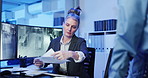 Women, security guard and documents at office by monitor for review, planning or surveillance strategy. People, paperwork and mentor with feedback in discussion, advice and notes for safety services