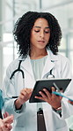 Woman, doctor and check tablet at hospital with planning, feedback and medical results of surgery. People, discussion and digital with staff update, healthcare report and brainstorming for treatment
