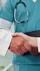 Handshake, medical and team with closeup of people in hospital for partnership, healthcare meeting and deal. Nurses, shaking hands and introduction with doctors in clinic for welcome and support