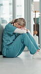 Nurse, woman and stress on floor in hospital for surgery fail, bad news and medical mistake. Healthcare, professional and anxiety for treatment crisis, burnout risk or overwhelmed with medicine doubt