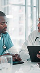 Men, doctors and meeting on tablet at hospital for planning, feedback and medical results of surgery. People, talking and digital with schedule update, healthcare report and brainstorming of solution