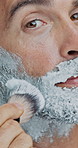 Closeup, man or beard with brush or cream for shave, hair removal or epilation on a white studio background. Portrait, male person or model with cosmetics, foam or soap for hygiene or facial grooming