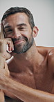Confident, face and skincare for man, studio and happy for glow of skin, cosmetics or dermatology. White background, smile and person with treatment for wellness, shine or aesthetic for beauty in USA