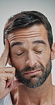 Pain, headache and face of man in studio with tension, migraine and medical crisis on white background. Strain, health and frustrated person massage temples for fatigue, burnout and head pressure