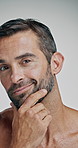 Confident, face and man with smooth skin, studio and skincare with cosmetics for glow and wellness. White background, aesthetic and person with treatment for beauty, dermatology and shine in Canada