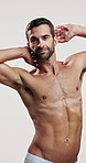 Studio, shirtless and skincare for man, beauty and facial treatment for glow of skin and dermatology. White background, grooming and person with routine for self care, cosmetics or smooth face in USA