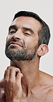 Itch, beard and face of man in studio for eczema, dermatitis and skin inflammation. Ingrown hair pain, folliculitis and scratching with person on white background for allergies, rash and symptoms