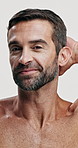 Studio, face and skincare for man, calm and facial treatment for glow of skin, beauty and dermatology. White background, grooming and person with routine for self care, cosmetics and confident in USA