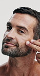 Studio, glow and skincare for man, cosmetics and facial treatment for moisture of skin, face and dermatology. White background, grooming and person with routine for self care, beauty and smile in USA