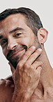 Studio, grooming and skincare for man, face and facial treatment for moisture of skin and dermatology. White background, cosmetics and person with routine for self care, beauty and smile in USA