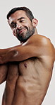 Fitness, muscle and stretching  with man in studio for sports athlete, workout and progress. Body care, warm up and bodybuilder with person on white background for training, exercise and wellness