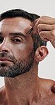 Man, face and beauty with tweezer for hair removal, grooming routine and selfcare on white background. Cosmetic care, serious portrait and male model with tool for brow trimming or styling in studio