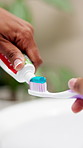 Hands, toothpaste and toothbrush in bathroom, home or product for cleaning mouth, hygiene or routine. Person, dental health and wellness with self care for plaque, gingivitis or fresh breath in house