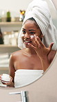 Happy, black woman and facial cream with mirror for skincare, morning routine or cosmetology in bathroom. Female person, smile or creme with moisturizer or container for face treatment at home spa