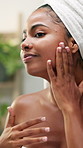 African woman, cream and skincare by mirror in bathroom for smooth texture, wellness and moisturizer. Girl, person and self care with lotion, cosmetics or routine for beauty with dermatology at house