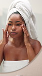 African woman, skincare and mirror with face, towel and bathroom with check for wrinkles, pimple or texture. Girl, person and self care with morning routine, cosmetics or inspection for acne in home 