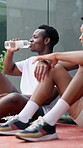 Happy men, break and tennis player with drink for hydration, rest or recovery together on court. Male people, athlete or friends with mineral liquid, aqua beverage or water for sport match or game