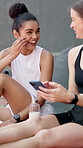 Social media, phone and friends with tennis court for game, break or competition joke. Laugh, bonding and women with athlete, smile and happy for exercise, wellness and training or workout practice