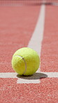 Tennis ball, sports and fitness with ground of court for competition arena, challenge match and training. Tournament, equipment and game with floor closeup in turf pitch in club for contest practice