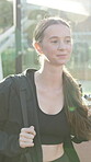 Sports, walking and smile with woman at tennis court of competition match, training and athlete. Workout, exercise and challenge with person at turf club for game, wellness and tournament practice