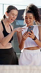 Women, friends and phone with laughing at tennis court for funny meme, point or video on web in summer. Girl, people and athlete on smartphone, mobile app and comic update on social media with sports