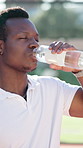 Black man, water and drinking with fitness for hydration, sport or break on tennis court. Male person, rest or thirst with mineral liquid or nutrition for natural sustainability, match or performance