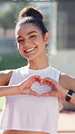 Girl, smile and heart hands at tennis court for sport, love and padel with fitness, training or symbol. Woman, person and happy athlete with face, gesture and care for game at competition in Brazil
