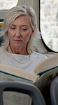 Mature woman, reading and book on bus with literature hobby, story information and public transport. Passenger, novel and ride entertainment for travel tourism, free time and guide of morning commute