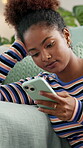 Phone, relax and thinking with woman on sofa in living room of home for app or social media browsing. Chatting, internet and text message with person in apartment for communication or networking