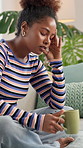 Tired, black woman or stress with headache or coffee on sofa for mistake or depression at home. Frustrated, female person or migraine with anxiety or drink for fatigue, burnout or overworked at house