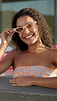 Face, party and woman with holiday in swimming pool for weekend, break or vacation. Relax, sunglasses or girl in water with smile, friends and people at hotel or lodge resort for summer getaway