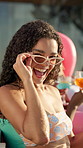 Smile, party and woman with holiday in swimming pool for weekend, break or vacation. Relax, sunglasses or girl in water with face, friends and people at hotel or lodge resort for summer getaway