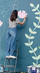Ladder, woman and painting wall for art, flower decoration or student with creative design outdoor. City, color or artist with brush for mural, community project or back for floral hobby with culture