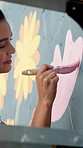 Woman, hands and artist with stroke on wall art for floral design, colorful creativity or community service. Female person, volunteer or outreach with paint for pink flower, mural activity or charity