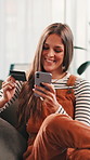 Credit card, phone and woman on sofa for online shopping, purchase and payment in home. Ecommerce, happy and person on smartphone for website sale, discount and internet banking in living room