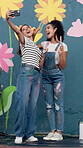 Wall art, women and mural selfie with smile for creative, community project and student hobby. Friends, peace sign and social media for flowers artist, diy decor and painter with expression outdoors