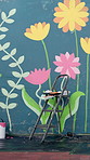 Paint, wall art and ladder with flower design for exterior decoration, community service or charity. Empty, space and colorful surface with creativity for DIY campaign, message or mural activity