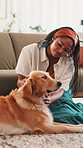 Happy, girl and playing with dog in home for bonding, connection and affection for pet care. Animal, golden retriever and owner with relax for companion, security and loyalty on floor with protection