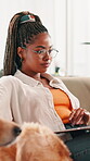 Home, dog and woman with laptop for remote work, editing information and content writer in lounge. Sofa, freelancer and journalist with tech for article research, news story and animal for companion