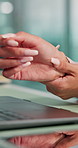 Hands, closeup and woman with wrist pain by laptop, writer with carpal tunnel or arthritis nerve tension. Inflammation, pressure and journalist with burnout, massage hurt or sore joint for relief